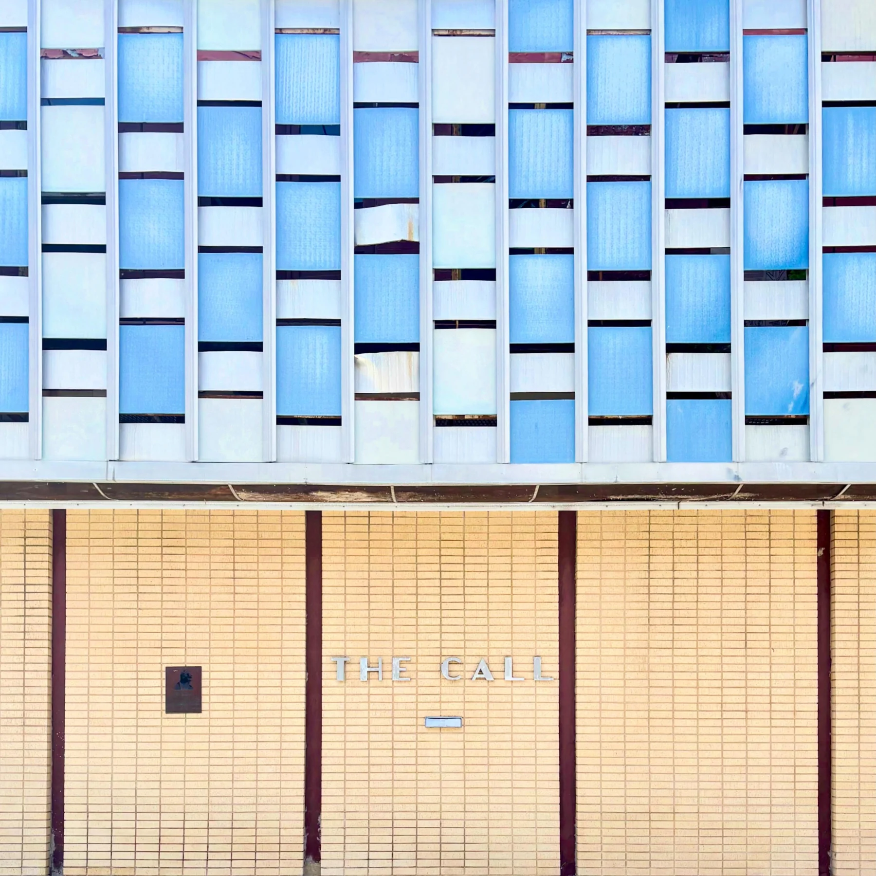 Repeating blue windows above a gold ground floor in Kansas City.