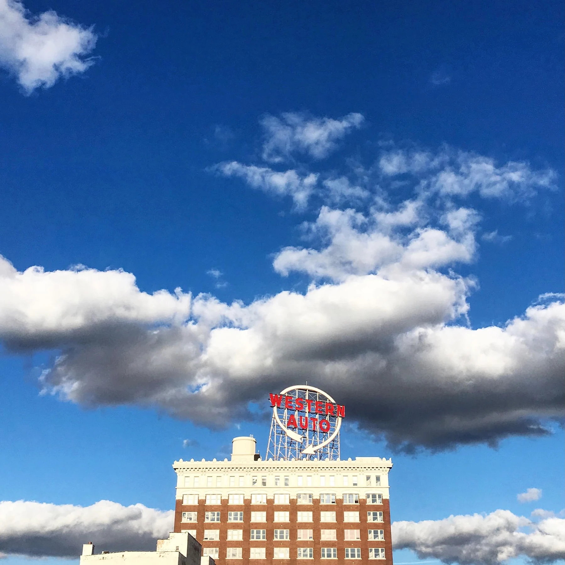 A Kansas City skyline landmark and clouds.